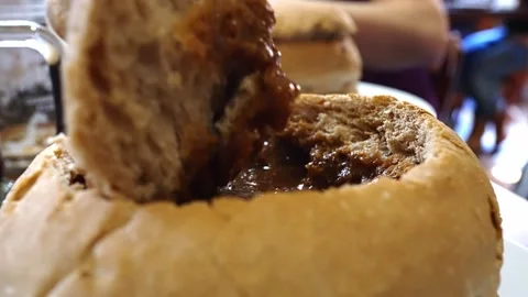 Goulash soup in bread, take off the bread lid. Video stock 271231945