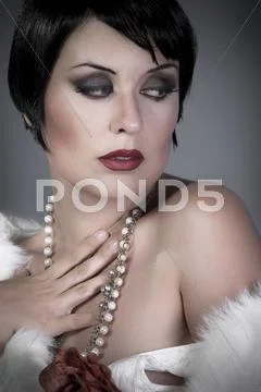 Gourgeos brunette flapper wearing pearls Stock Photos