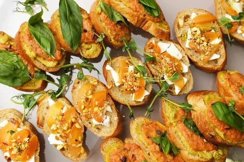 Gourmet appetizer platter featuring assorted bruschetta topped with vibrant Stock Photos