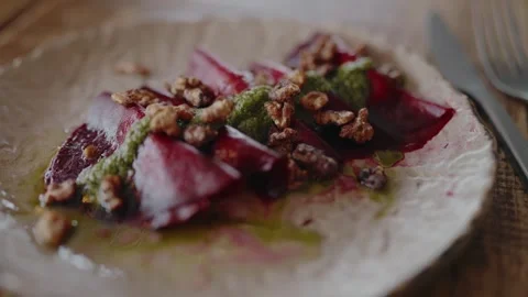 Gourmet Beetroot Salad with Walnuts and Pesto on Rustic Plate Stock Footage 344855781
