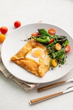 Gourmet breakfast with fried egg in a pancake Stock Photos