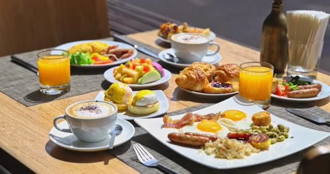 Gourmet Breakfast Spread with Eggs Bacon Coffee and Juice Stock Footage 331535071