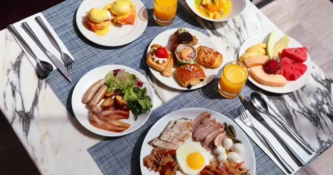 Gourmet breakfast spread on elegant marble table with diverse dishes Stock Footage 318117429