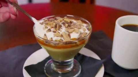 Gourmet Butterscotch Pudding with spoon scooping out a bite Stock-Footage 75761653