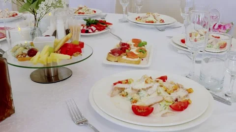 Gourmet caesar salad and appetizers arranged on crisp white tablecloth Stock Footage 327217943