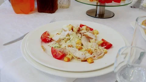 Gourmet caesar salad featuring grilled chicken, ripe tomatoes, crispy croutons Stock Footage 336429163