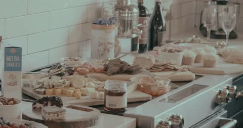 Gourmet cheese and snack spread on kitchen counter 스톡 동영상 232444204