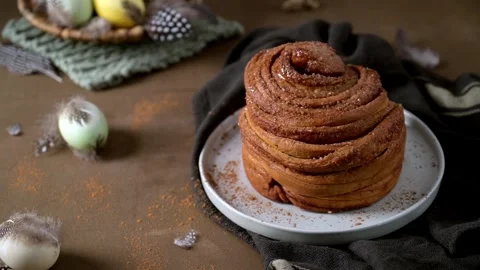 Gourmet Cinnamon Roll with Easter Table Setting and Spring Decor Stock Footage 332229466