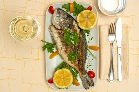 Gourmet Cooked Fish with Lemon and Herbs.. Stock Photos