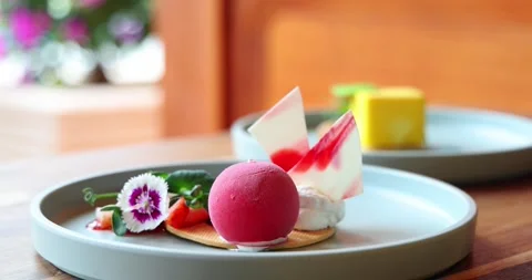 Gourmet dessert plate featuring vibrant raspberry mousse, artistic Stock-Footage 315577611