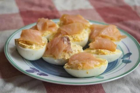 Gourmet deviled eggs with smoked salmon on a rustic tablecloth Stock Photos