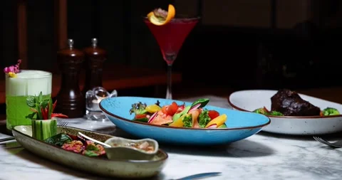Gourmet dining setup in elegant restaurant featuring colorful dishes, Stock Footage 318120023