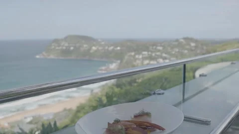 Gourmet Dish Served on Glass Table With Scenic Sydney Coastal View Outdoors Stock Footage 345725804