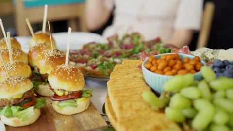 Gourmet grazing table spread with sliders and fresh fruit Stock Footage 273788597