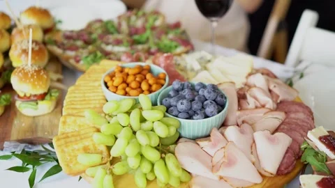 Gourmet grazing table spread with sliders and fresh fruit Stock Footage 273788609