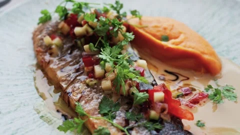 Gourmet grilled fish dish with mashed sweet potato and fresh salsa served o.. Stock Footage 339763913