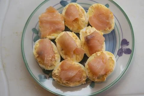 Gourmet keto appetizers deviled eggs topped with smoked salmon slices Stock Photos