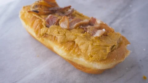 Gourmet Maple Bacon Donut Falling in Slow Motion Stock Footage 106083789