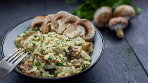 Gourmet mushroom risotto over a rustic background Stock Photos