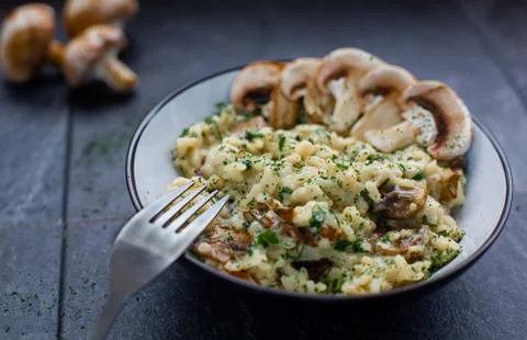 Gourmet mushroom risotto over a rustic background Stock Photos