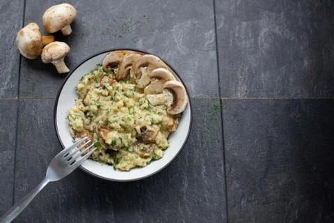Gourmet mushroom risotto over a rustic background Stock Photos