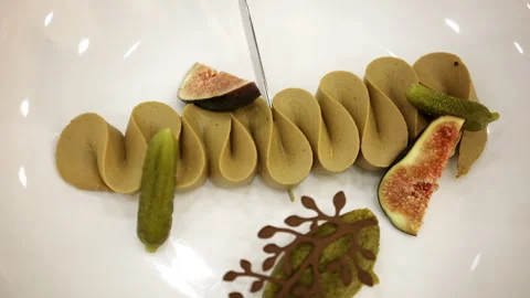 Gourmet plated dish with artistic presentation, featuring figs and decorative Stock Footage 329396710
