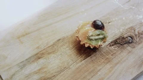 Gourmet plating process view: arranging assorted tartlets in neat rows Stock Photos