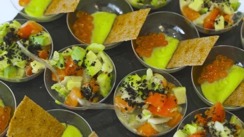 Gourmet portion appetizers with caviar and avocado in glass bowls Stock Footage 314458667
