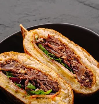 Gourmet Pulled Beef Sandwich On Dark Plate Stock Photos