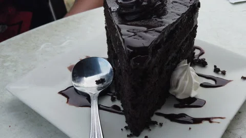 Gourmet slice of chocolate cake served on a plate at table Video stock 157348710