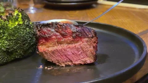Gourmet steak dinner plate with mashed potatoes, carrots, broccoli, cherry Stock Footage 322662852