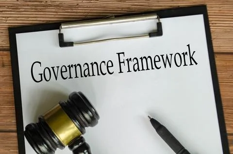 Governance Framework text on white paper clipboard surrounding with gavel. .. Stock Photos