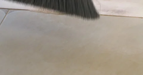 The governess sweeps the floor with a brush. Stock Footage 305647943