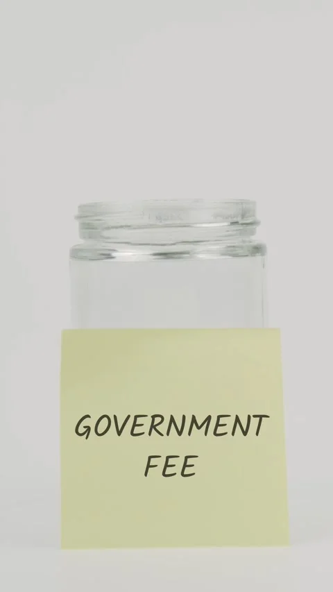 Government fee text or word on yellow sticky note attached to glass jar Stock Footage 311738535