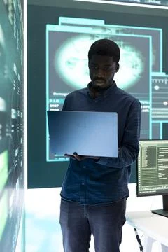 Governmental hacker exploiting server systems in high tech operations center 스톡 사진