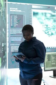 Governmental hacker woman working with a tablet and big screen Stock Photos