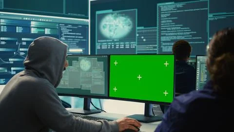 Governmental hackers working on computer with green screen Stock Photos