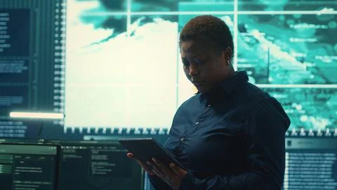 Governmental hackers working on computer network in high tech office Stock Photos