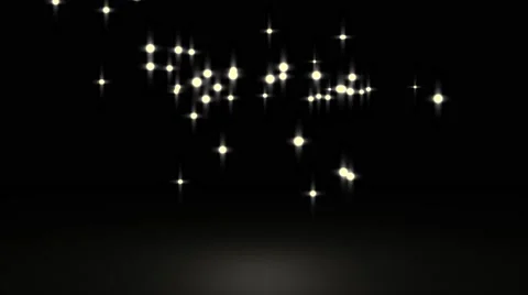 Gowing star particle in random direction with bounce on spotlight ground abst Stock Footage 65767759