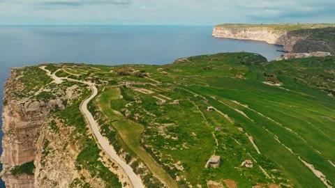 Gozo island. Green fields, rocks and cliffs, sea. Malta island. Drone view Stock Footage 329989023