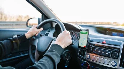 Gps device map system. Global positioning system on smartphone screen in auto Stock Photos