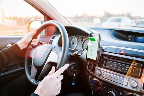 Gps device map system. Global positioning system on smartphone screen in auto Stock Photos