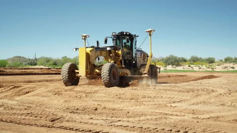 GPS, Laser guided Crawler Tractor shoveling dirt to grade the ground Stock Footage 217557133