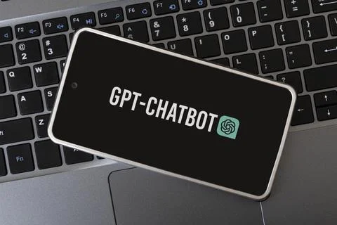 GPT Chatbot logo seen on screen smartphone and laptop. Stock Photos
