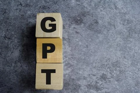 GPT - Generative Pre-Trained on stacked wooden cubes on the table. Stock Photos