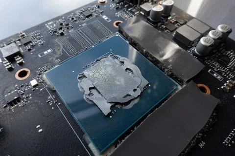 GPU processor with old dry thermal paste on electronic circuit board Stock Photos