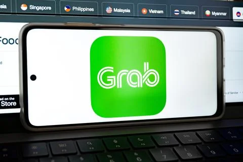 Grab app logo on smartphone screen showing southeast asia technology 写真素材