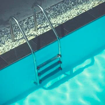 Grab bars ladder in swimming pool Stock Photos