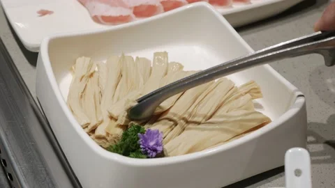 Grab fresh bean curd stick ready to cook in hotpot, Sichuan Hotpot Style Stock Footage 202137952