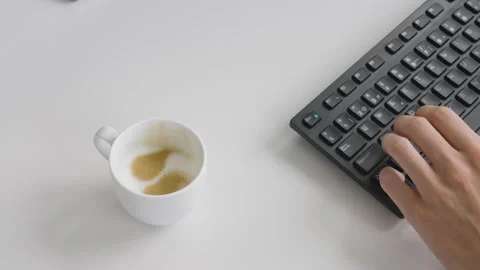 Grabbing Coffe while working on Computer Video stock 220603305